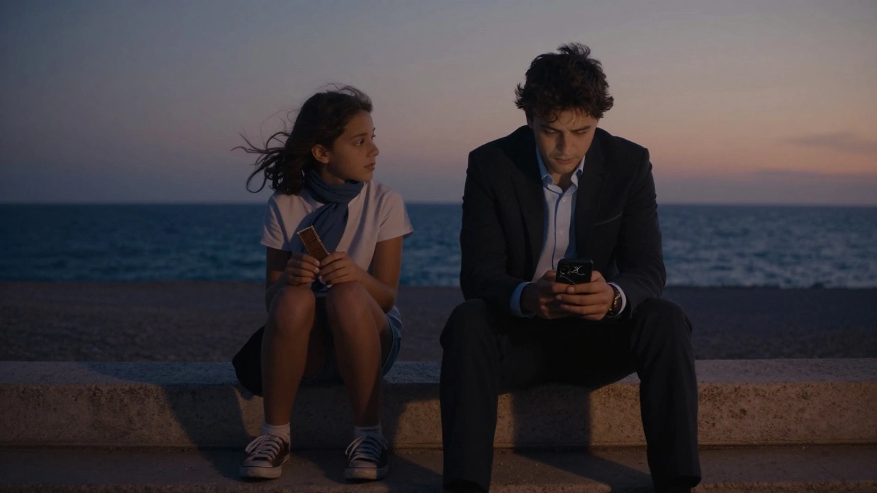 A man and teenager sit silently on steps overlooking Nice harbor, sharing chocolate in twilight.